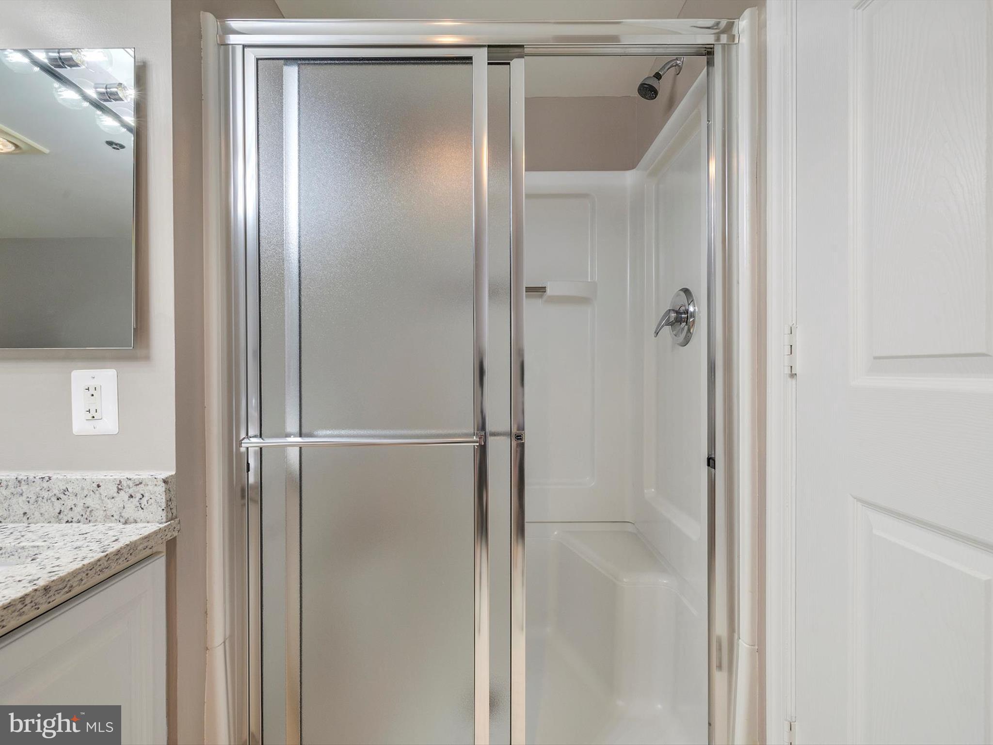 14809 Pennfield Circle, Unit 406 Silver Spring, MD 20906 - Photo 41 of 45 a bathroom with a glass shower door