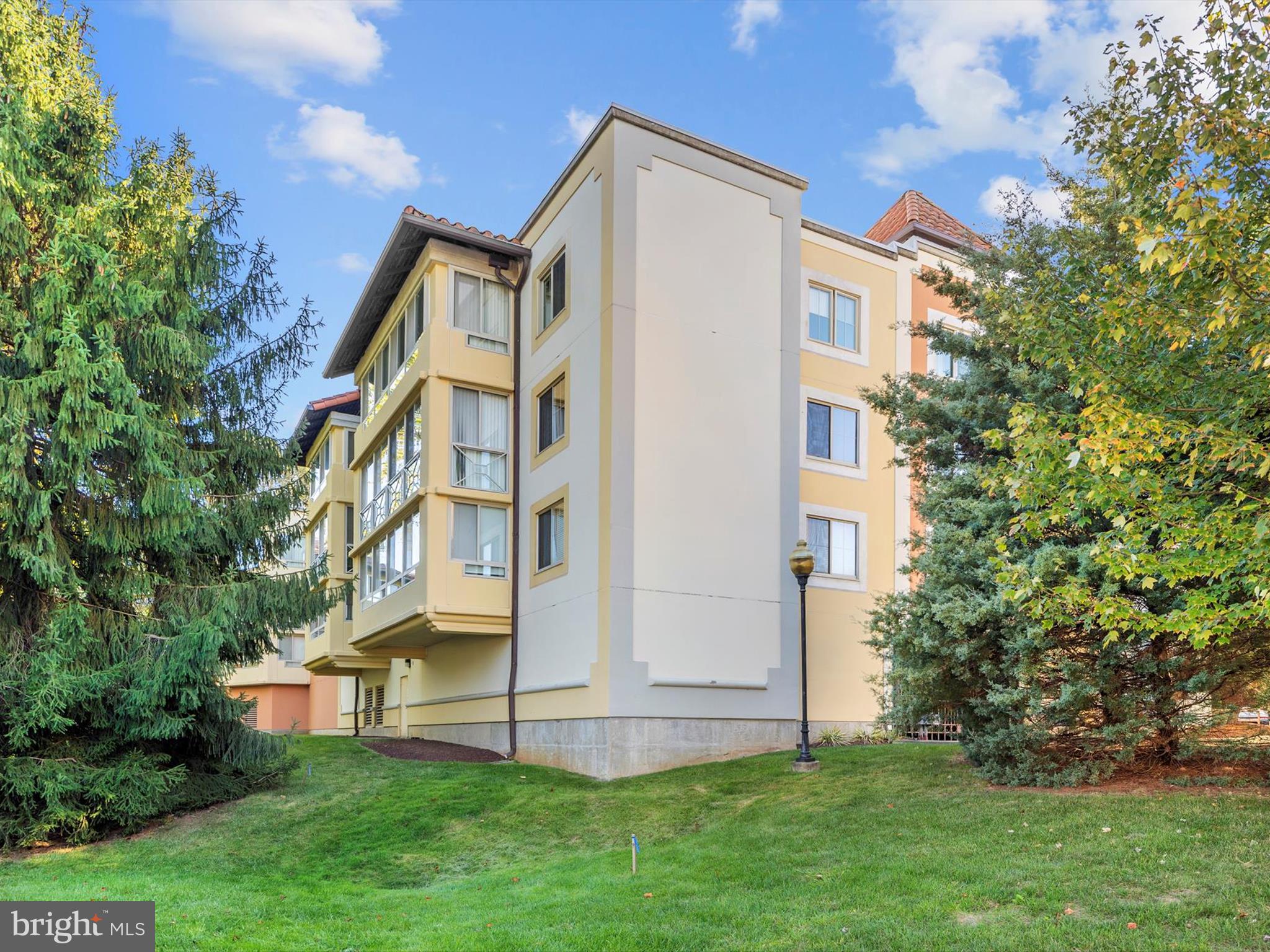 14809 Pennfield Circle, Unit 406 Silver Spring, MD 20906 - Photo 44 of 45 a view of a white building among the tall tree