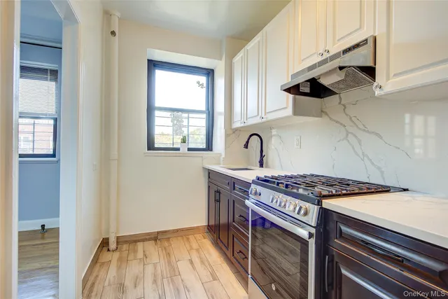 a kitchen with stainless steel appliances granite countertop a stove and a sink