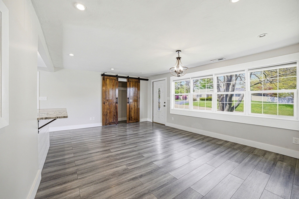 157 Errol Road Brockton, MA 02302 - Photo 14 of 34 a view of an empty room with a window and wooden floor