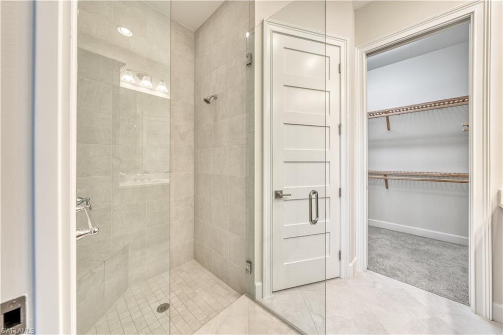 6421 Carnival Road Naples, FL 34113 - Photo 19 of 28 a bathroom with a shower and closet