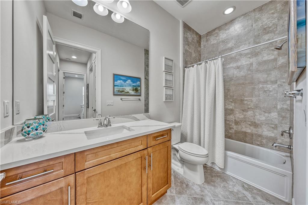 6421 Carnival Road Naples, FL 34113 - Photo 21 of 28 a bathroom with a sink a toilet and shower
