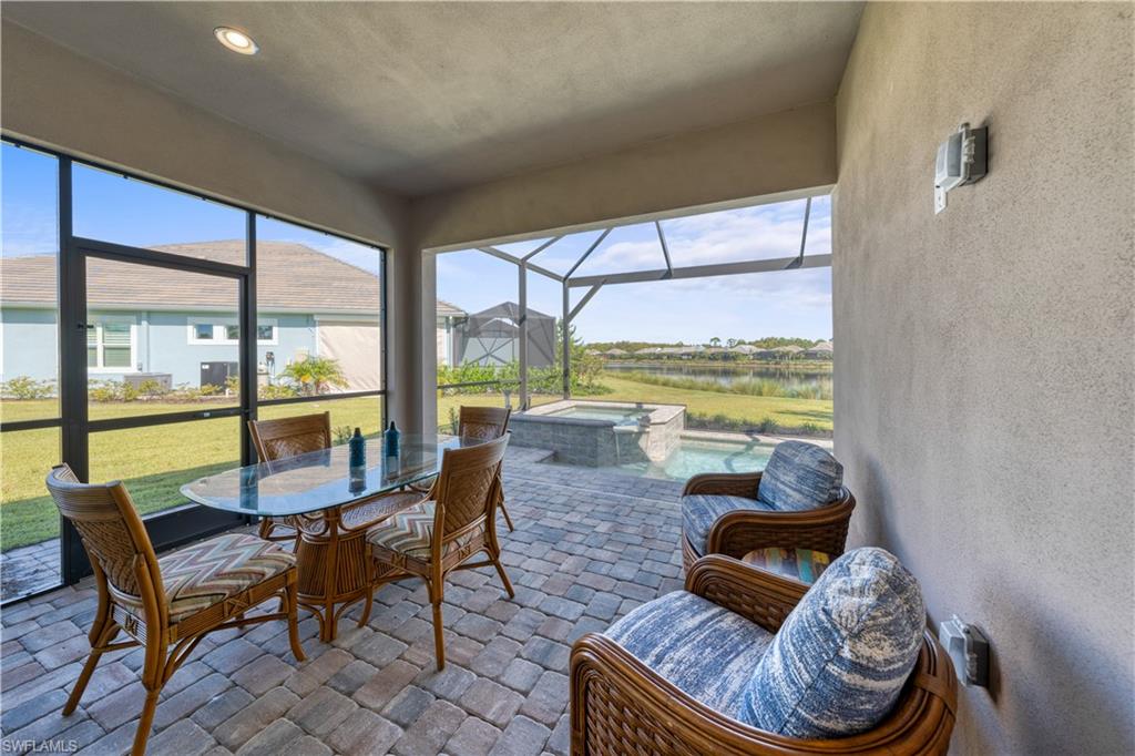 6421 Carnival Road Naples, FL 34113 - Photo 28 of 28 a living room with furniture and a floor to ceiling window
