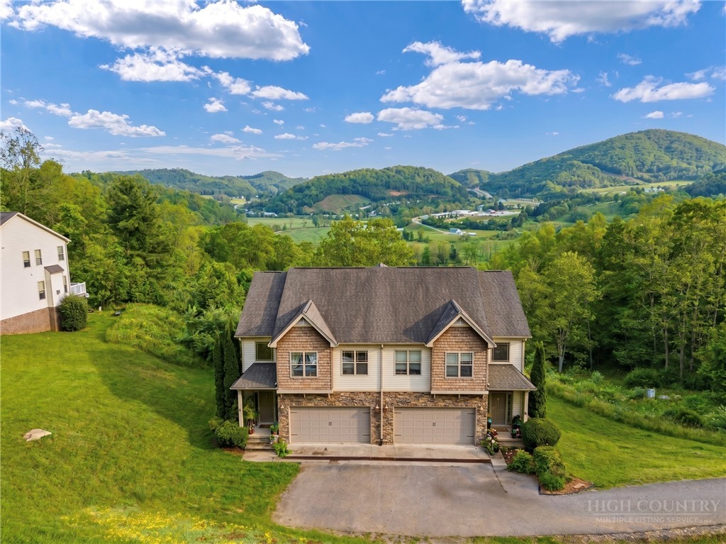 an aerial view of a house with a big yard