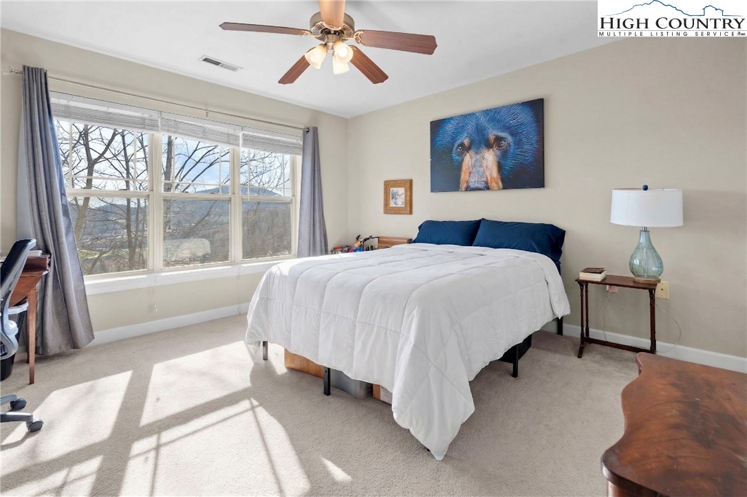 166 Azor Court, Unit 2A Boone, NC 28607 - Photo 14 of 38 a bedroom with a bed and a large window