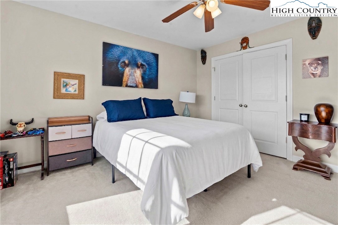 166 Azor Court, Unit 2A Boone, NC 28607 - Photo 15 of 38 a bedroom with a bed and a chandelier