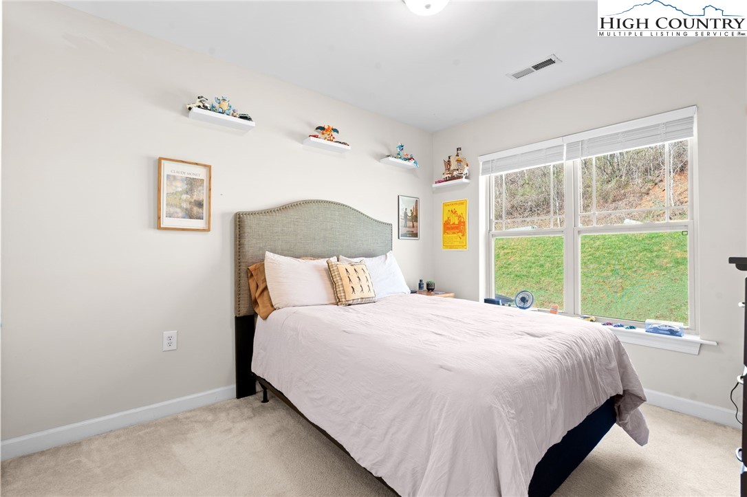 166 Azor Court, Unit 2A Boone, NC 28607 - Photo 20 of 38 a bedroom with a bed and a window