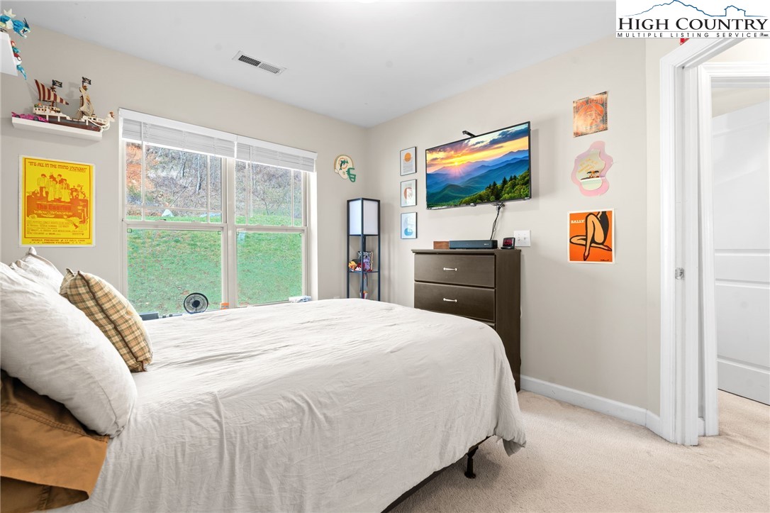 166 Azor Court, Unit 2A Boone, NC 28607 - Photo 21 of 38 a bedroom with a bed and a flat screen tv