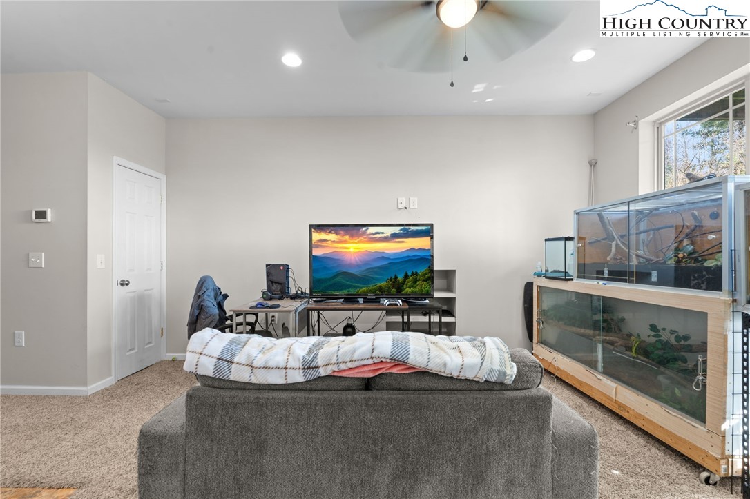 166 Azor Court, Unit 2A Boone, NC 28607 - Photo 25 of 38 a living room with furniture and a flat screen tv