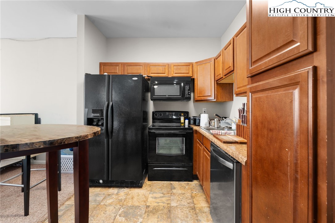 166 Azor Court, Unit 2A Boone, NC 28607 - Photo 27 of 38 a kitchen with stainless steel appliances granite countertop a refrigerator a stove and a sink