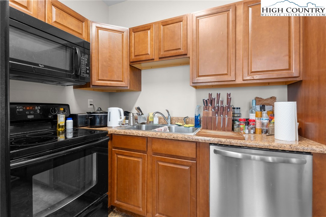 166 Azor Court, Unit 2A Boone, NC 28607 - Photo 28 of 38 a kitchen with stainless steel appliances granite countertop a sink stove and microwave