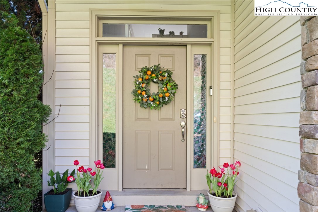 166 Azor Court, Unit 2A Boone, NC 28607 - Photo 3 of 38 a vase with flowers sitting on a wooden door