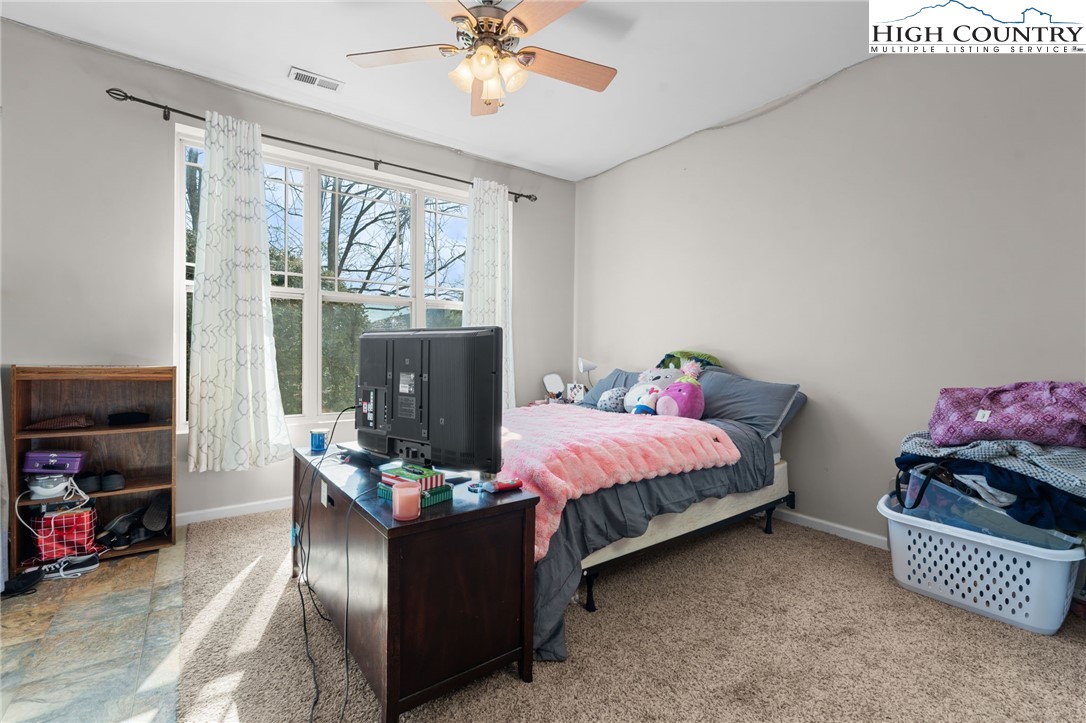 166 Azor Court, Unit 2A Boone, NC 28607 - Photo 31 of 38 a bed room with a bed mirror and a window