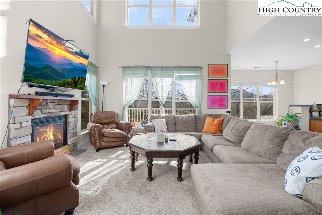 166 Azor Court, Unit 2A Boone, NC 28607 - Photo 5 of 38 a living room with fireplace furniture and a flat screen tv