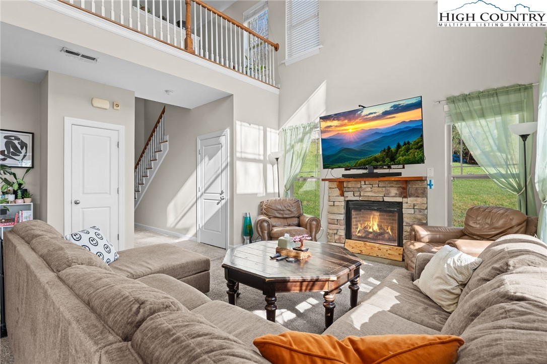 166 Azor Court, Unit 2A Boone, NC 28607 - Photo 6 of 38 a living room with furniture a fireplace and a flat screen tv