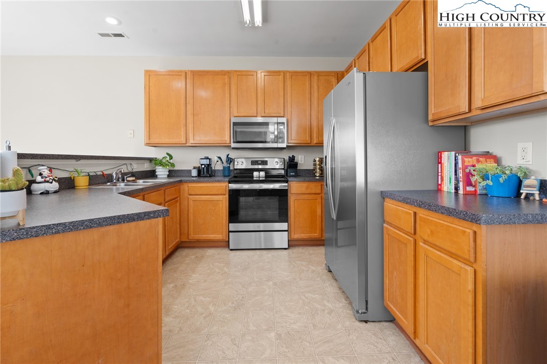 166 Azor Court, Unit 2A Boone, NC 28607 - Photo 7 of 38 a kitchen with stainless steel appliances granite countertop a refrigerator stove and sink