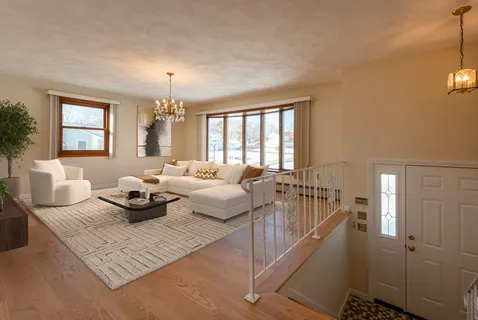 a living room with furniture and a chandelier