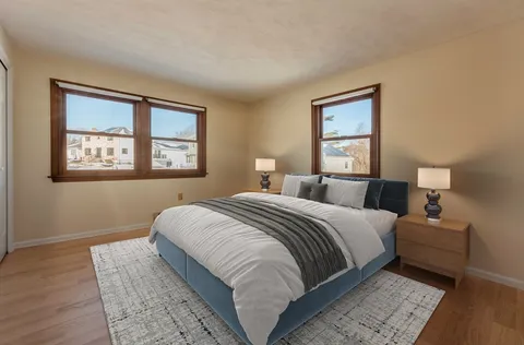 a bedroom with bed and a window