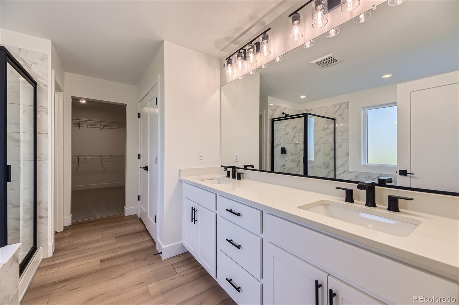 42972 Colonial Trail Elizabeth, CO 80107 - Photo 13 of 27 a spacious bathroom with a double vanity sink mirror and double