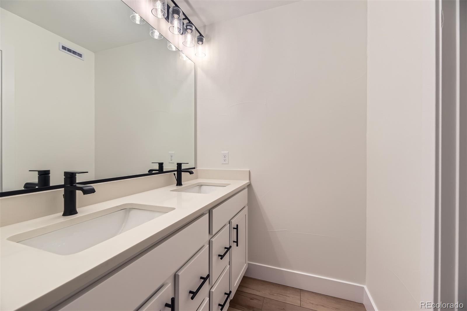 42972 Colonial Trail Elizabeth, CO 80107 - Photo 19 of 27 a bathroom with a sink and a mirror