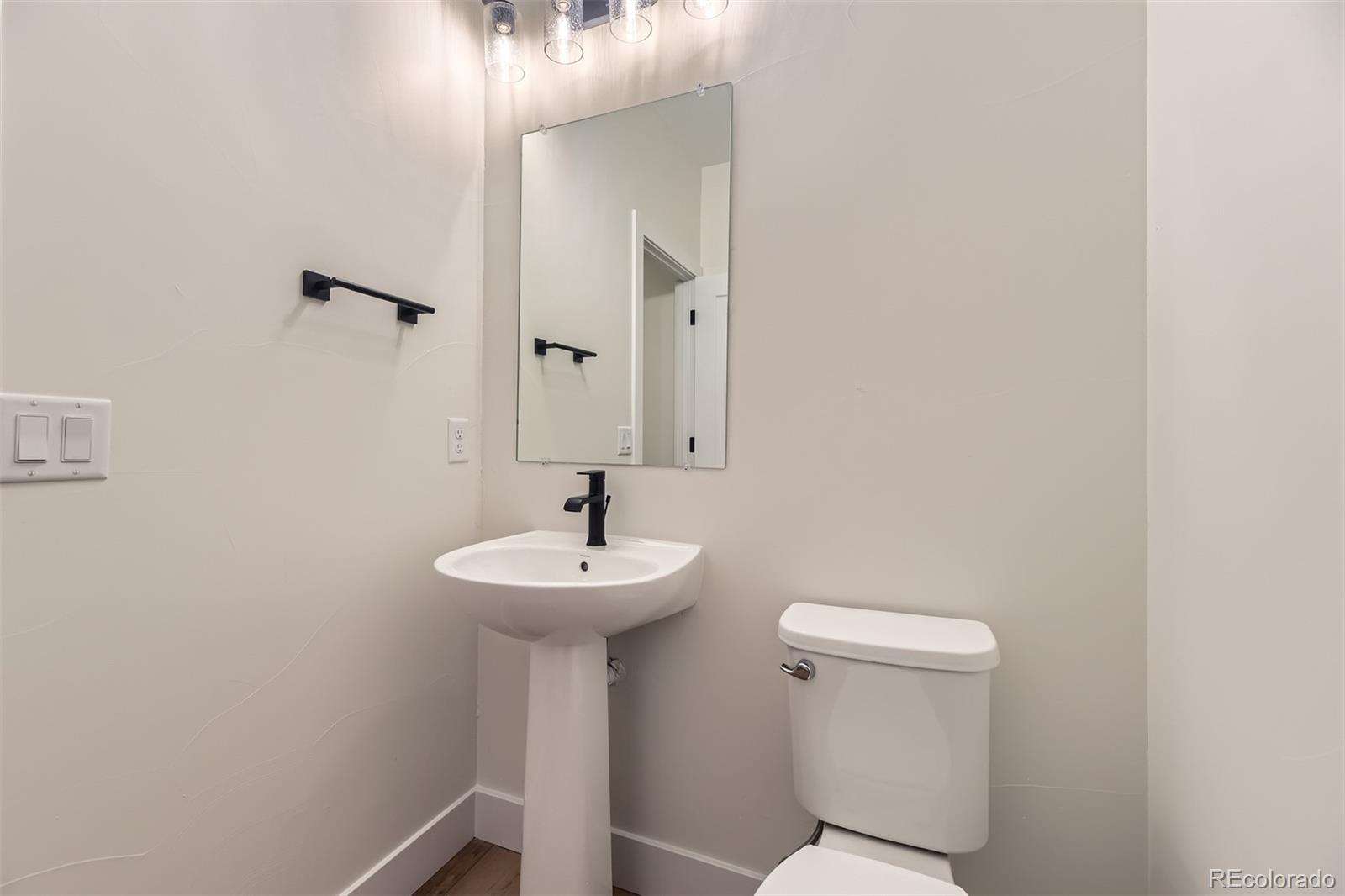42972 Colonial Trail Elizabeth, CO 80107 - Photo 20 of 27 a bathroom with a sink a mirror and toilet