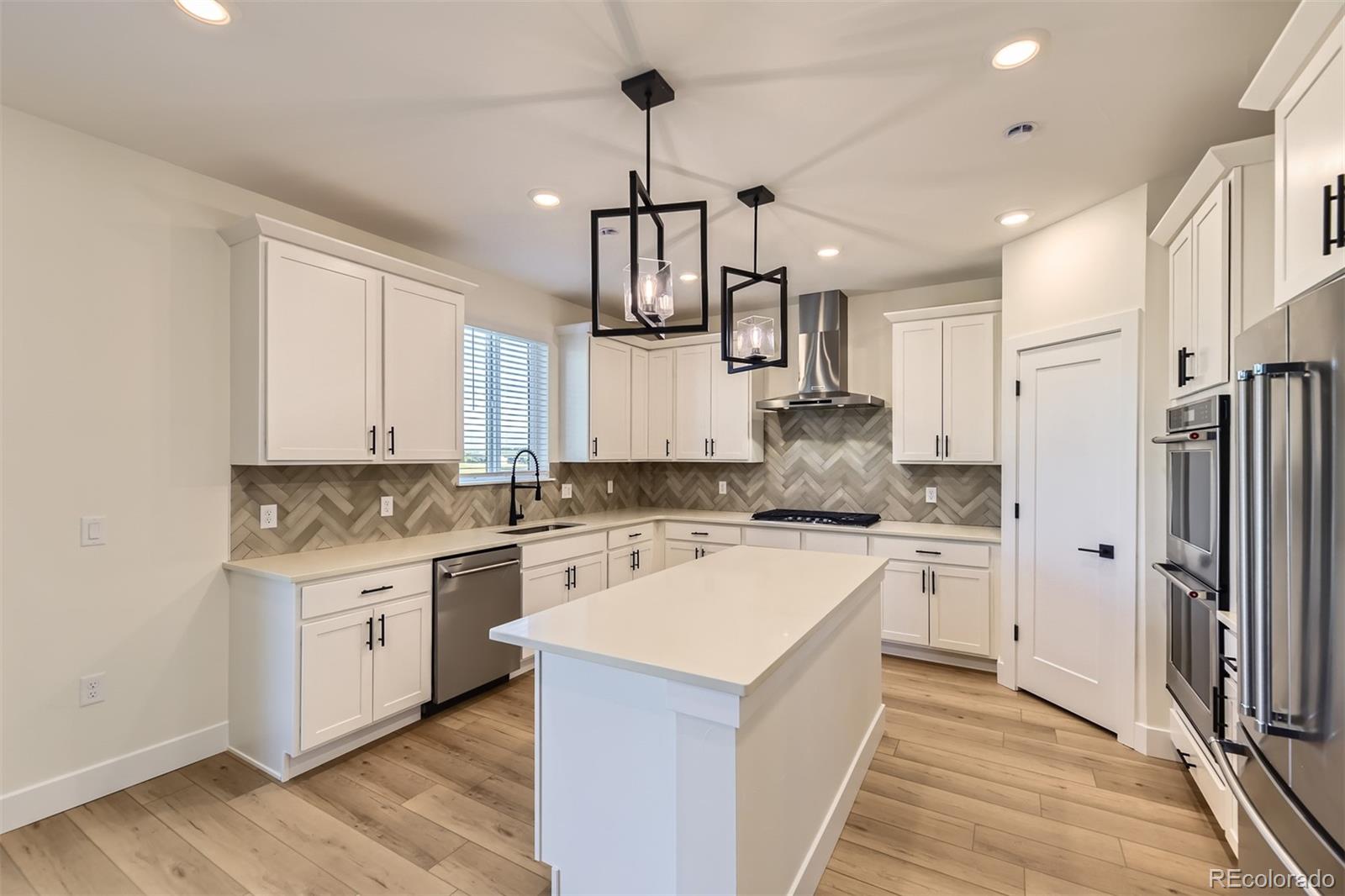 42972 Colonial Trail Elizabeth, CO 80107 - Photo 4 of 27 a kitchen with a stove a sink and a refrigerator