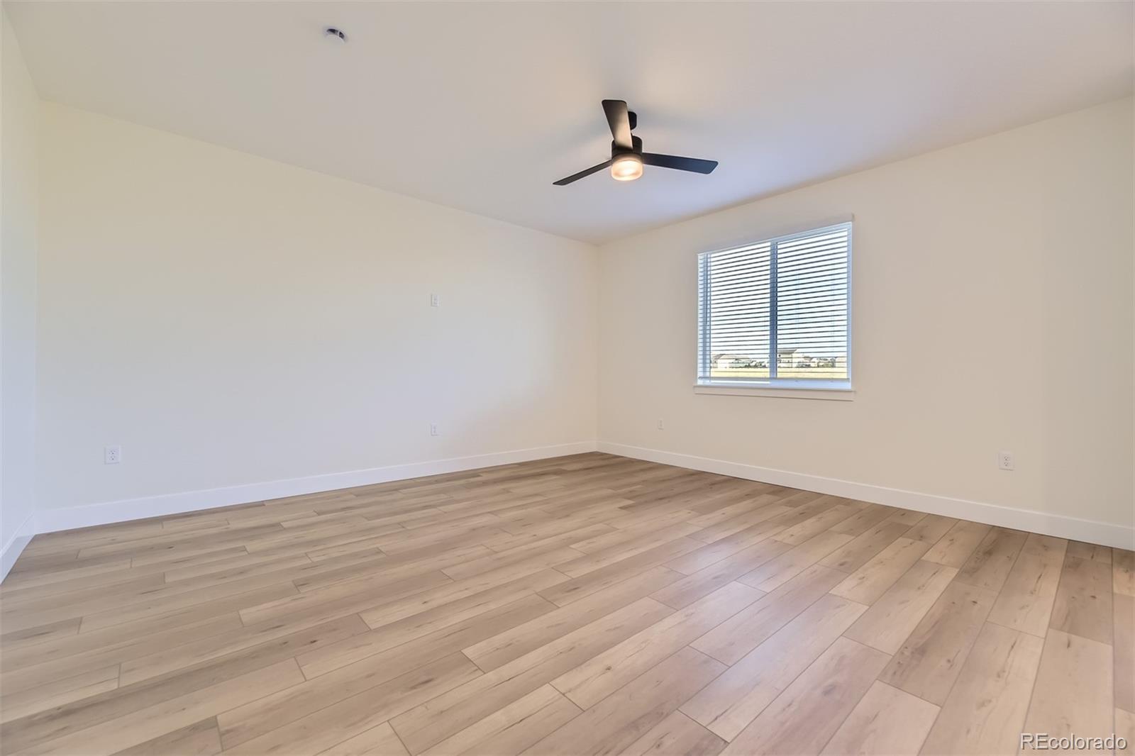 42972 Colonial Trail Elizabeth, CO 80107 - Photo 10 of 27 a view of empty room with wooden floor and fan