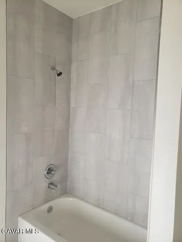 a bathroom with a tub and shower