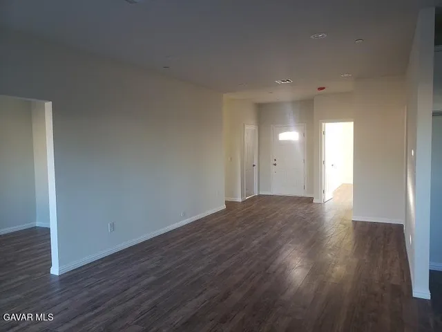 a view of a room with wooden floor and window