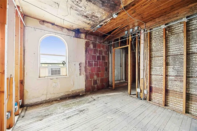 a view of a room with wooden floor and windows