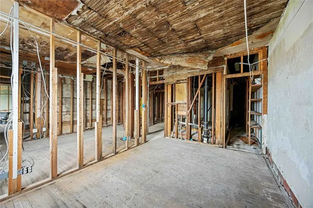 a empty room with a wooden floor and a window