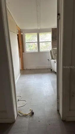 a view of an empty room with a window