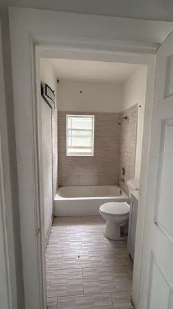 a bathroom with a toilet a sink and bathtub