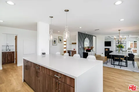 a view of living room with furniture and wooden floor