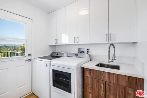 a view of a kitchen with sink dryer and washer