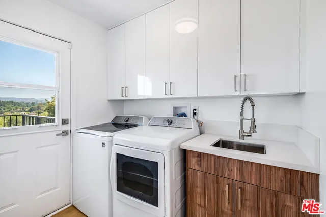 a view of a kitchen with sink dryer and washer