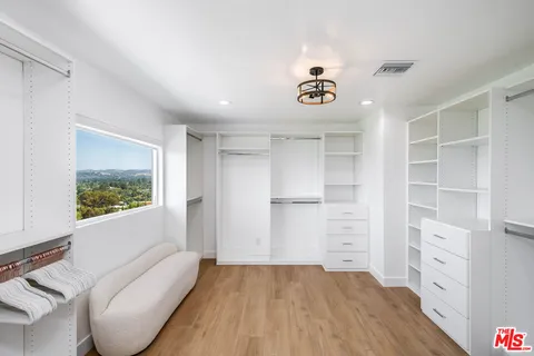 a view of room with window and cabinet