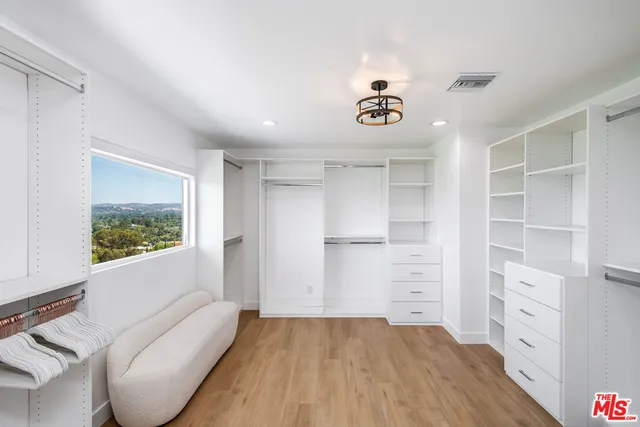 a view of room with window and cabinet