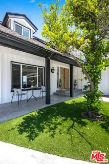 a view of a house with a yard and sitting area