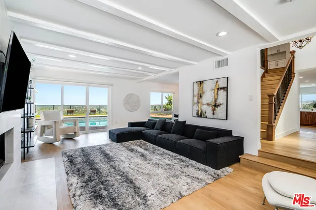 a living room with fireplace furniture and a flat screen tv