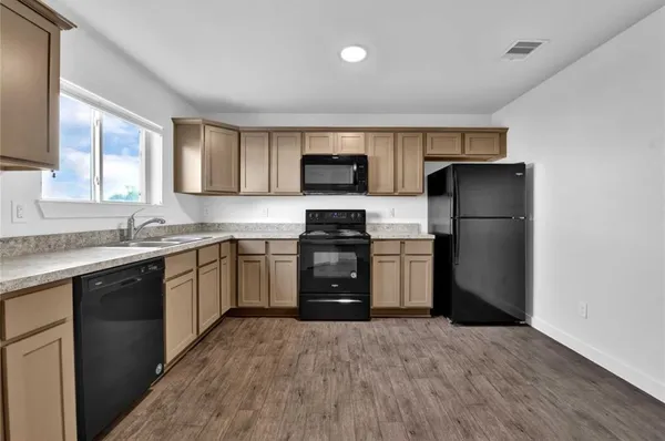a kitchen with a refrigerator stove and sink