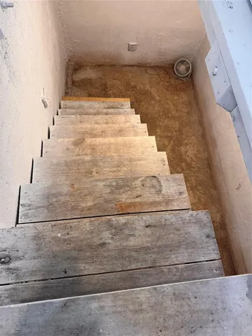 a view of a house with a big yard and large trees