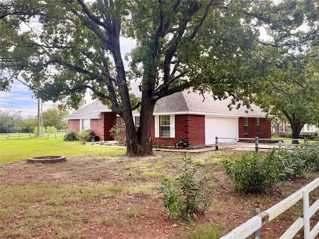 a house that has a tree in front of it