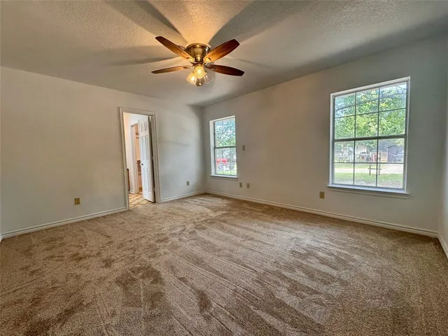 a view of a livingroom with a ceiling fan and window