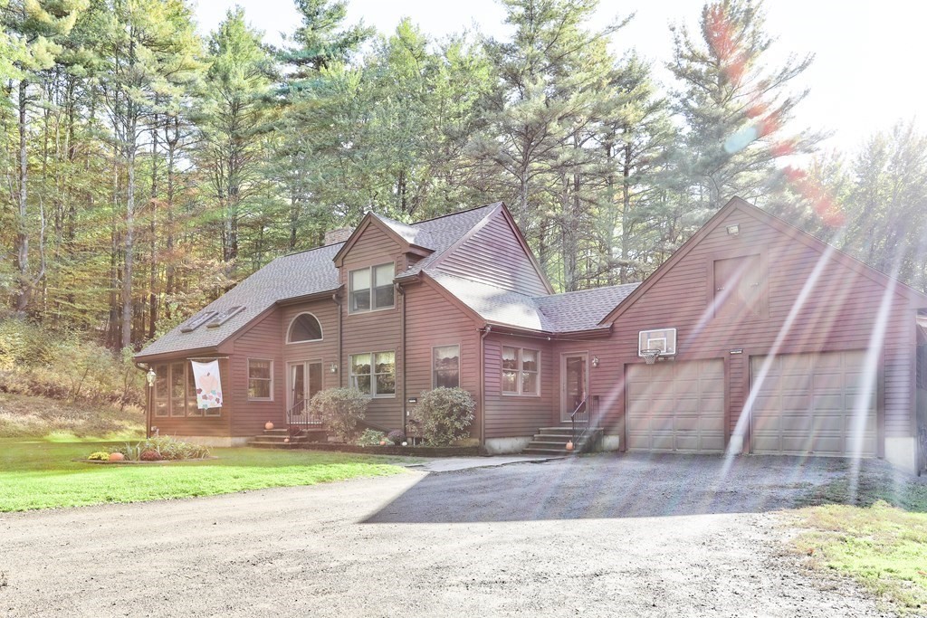 291 Mountain Road Gill, MA 01354 - Photo 35 of 35 a front view of a house with a yard and garage
