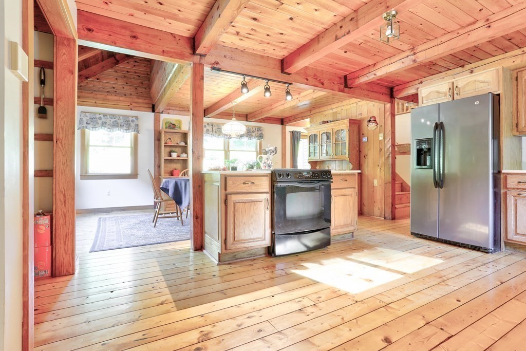 291 Mountain Road Gill, MA 01354 - Photo 8 of 35 a view of a hallway with wooden floor and a refrigerator