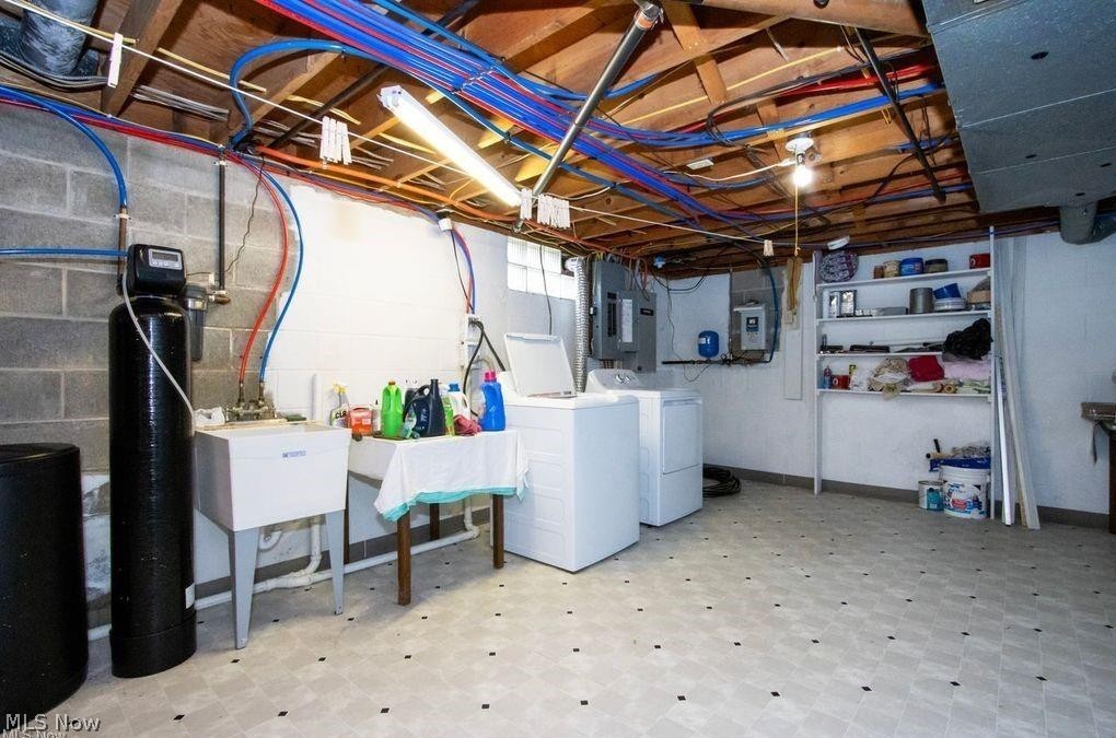 2530 Tuckahoe Road Wooster, OH 44691 - Photo 29 of 29 Utility area featuring a laundry sink, exposed wood ceiling joists, overhead strip lighting, and a water softener system