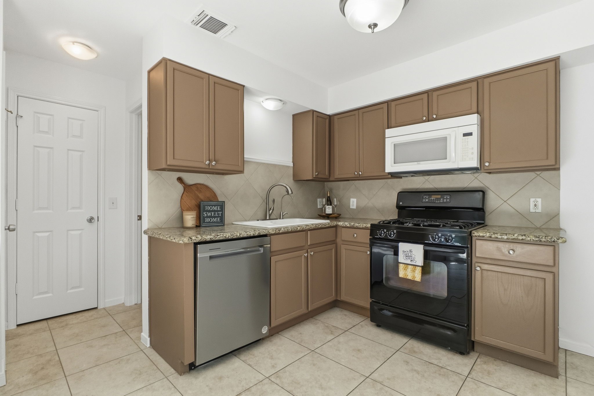 11907 Ezekiel Road Tomball, TX 77375 - Photo 14 of 39 a kitchen with stainless steel appliances granite countertop a stove a sink and a microwave
