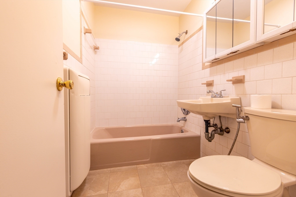 71 Nicholas Road, Unit H Framingham, MA 01701 - Photo 13 of 29 a bathroom with a sink a toilet and shower