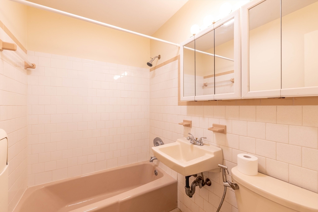 71 Nicholas Road, Unit H Framingham, MA 01701 - Photo 14 of 29 a bathroom with a sink a toilet and shower